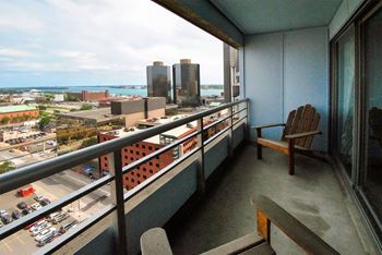 a balcony with a view of a city and the ocean